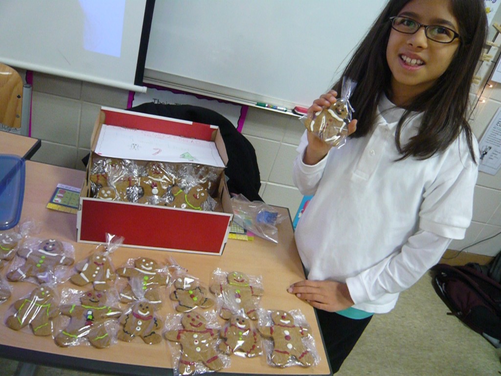 Olivia selling her homemade gingerbread cookies at her class market day.